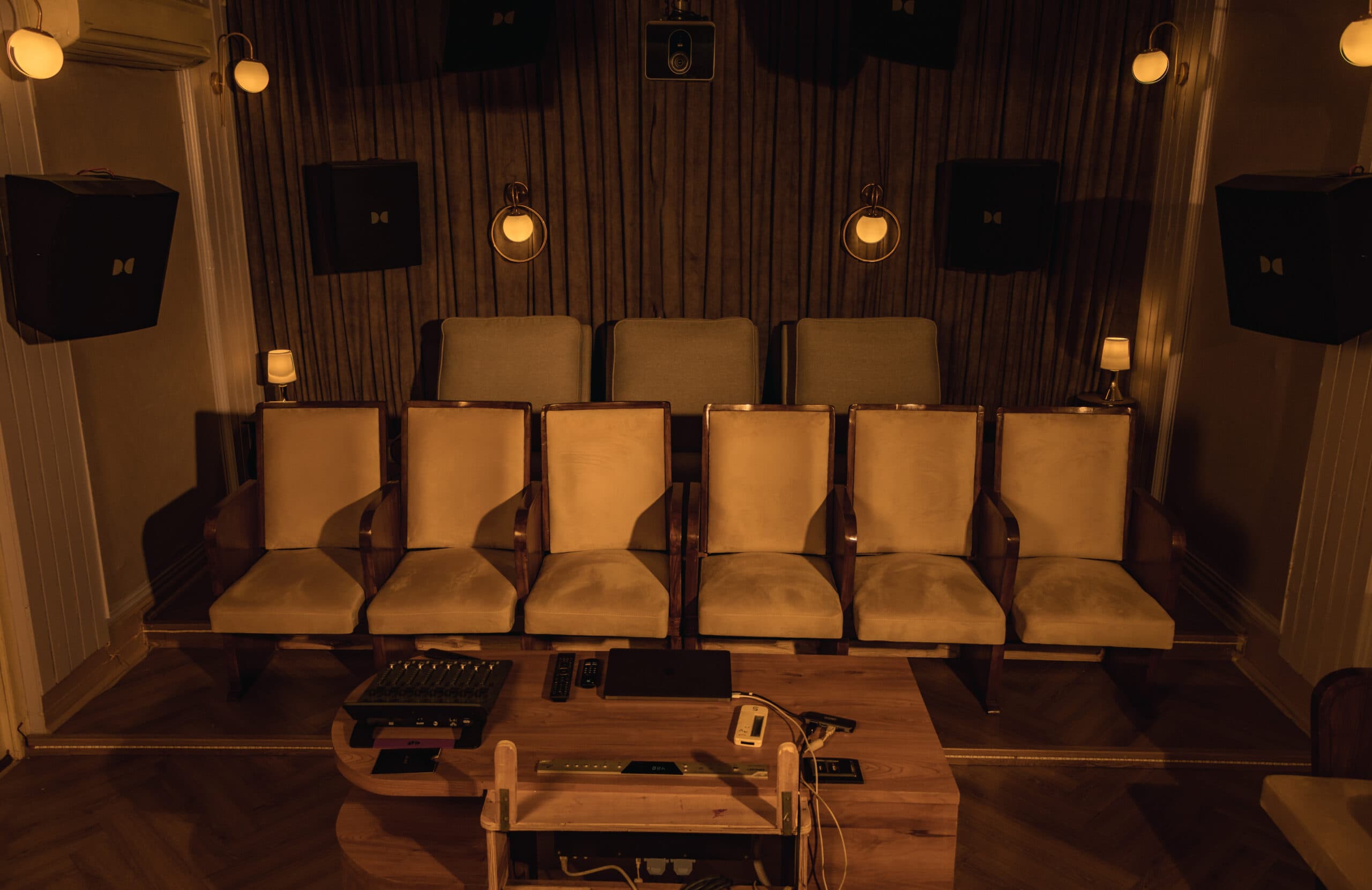 Theatre seating seen head-on across the mix desk, framed by Dolby surround speakers