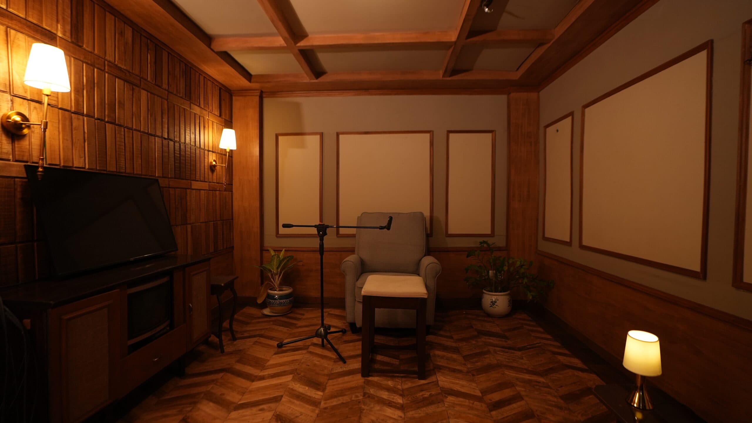 The ADR room, with an armchair, footstool and boom microphone facing a wall-mounted screen